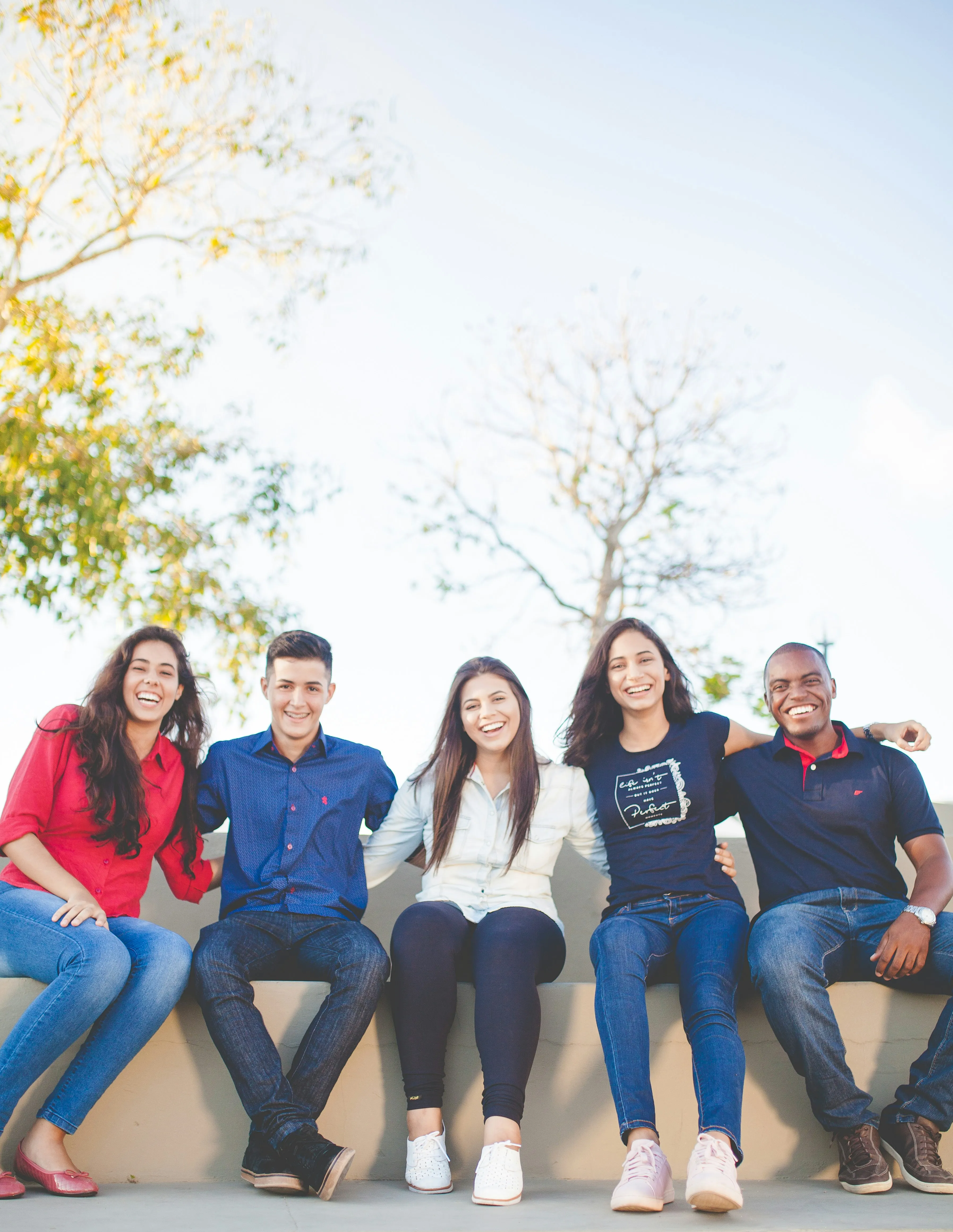 A group of smiling students sitting outdoors